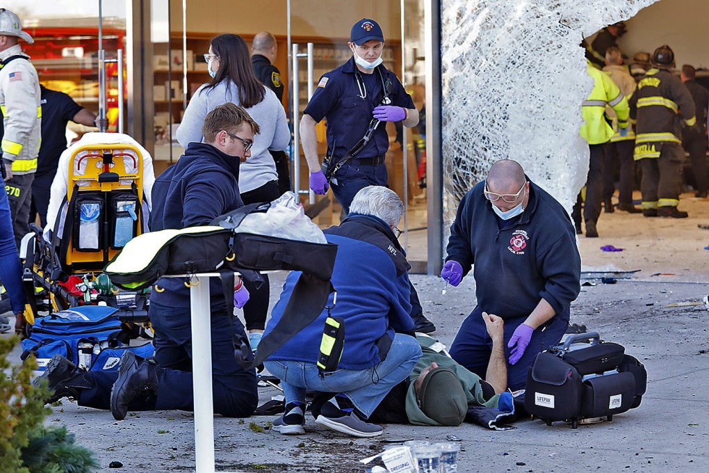 Emergency workers aid injured shoppers after an SUV drove into a Boston-area Apple store on Monday. Photo: The Patriot Ledger via AP