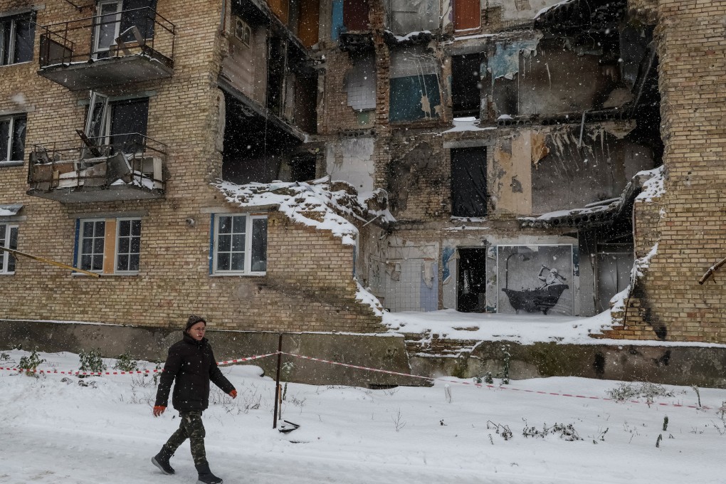 A local resident walks past a destroyed building in the Ukrainian village of Horenka on November 19. Photo: Reuters