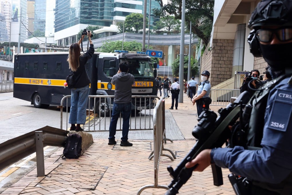 Former Apple Daily executives arrive at the High Court on Tuesday under police escort. Photo: K. Y. Cheng