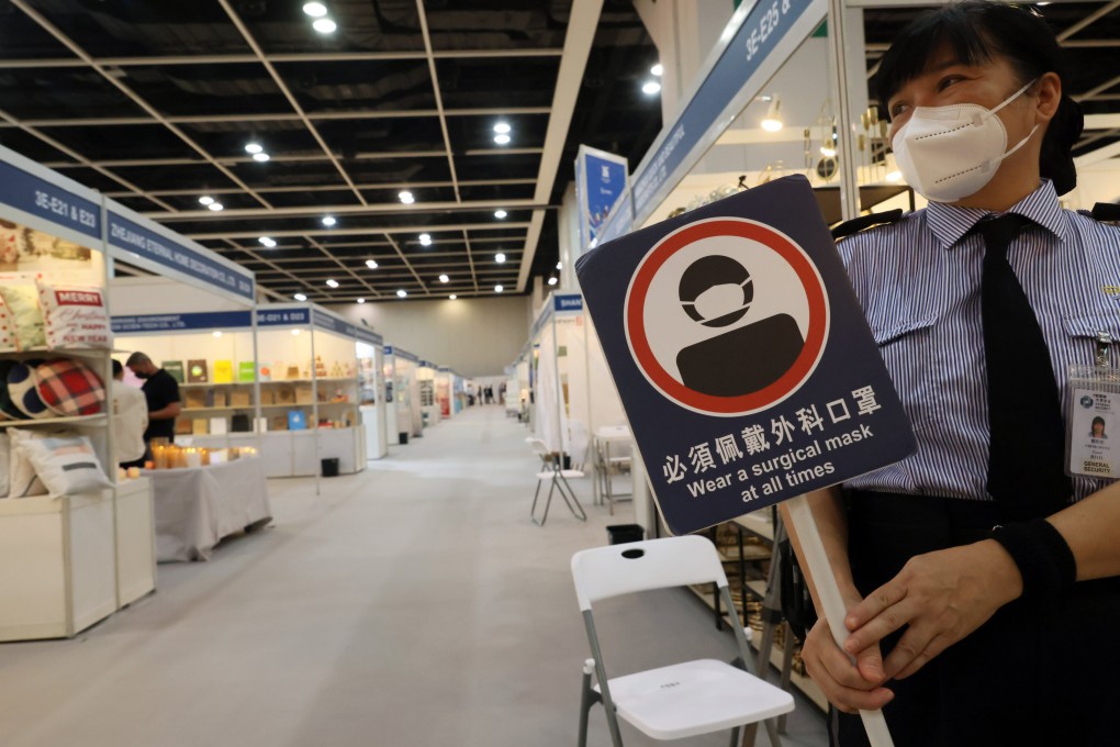 A security staff carries a placard to remind guests to wear a mask at all times at Mega Show at the Hong Kong Convention and Exhibition Centre in Wan Chai on November 15. The four-day international sourcing trade fair features items mainly produced in Asia for international buyers, including houseware, toys and baby products. Photo: Dickson Lee