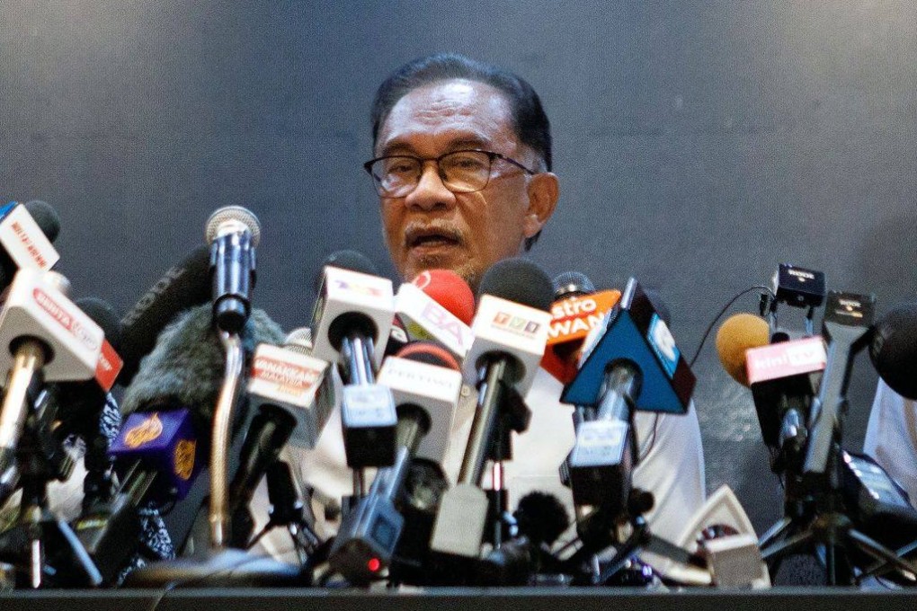 Anwar Ibrahim, Malaysia’s opposition leader (centre) speaks during a news conference on November 21. Anwar, who has come tantalisingly close to leading Malaysia during his tumultuous political career, is suddenly on the cusp of clinching the top job but a final hurdle stands in his way. Photo: Bloomberg