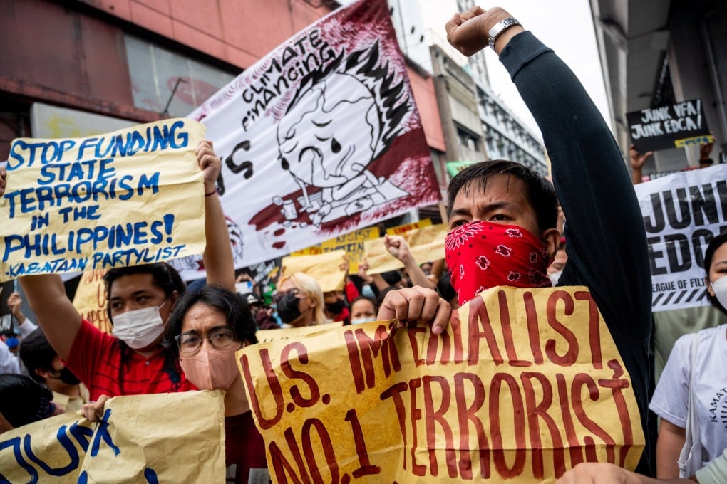 Filipino protesters hold placards during a protest against Kamala Harris’s visit. Photo: Reuters