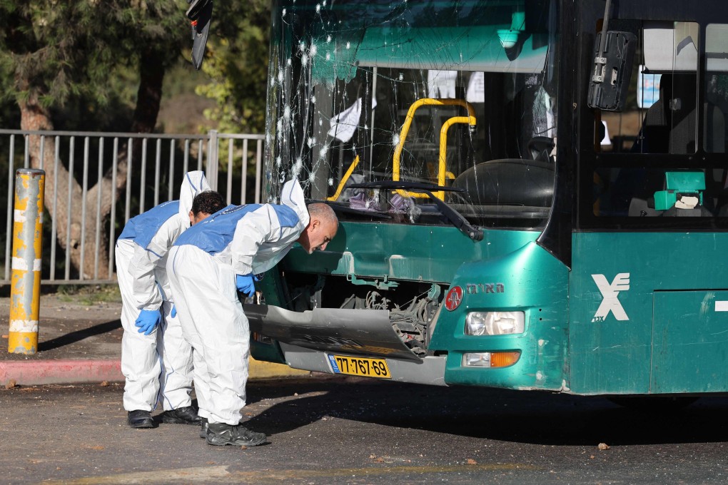 Israeli forensic experts work at the scene of an explosion at a bus stop in Jerusalem on Wednesday. AFP