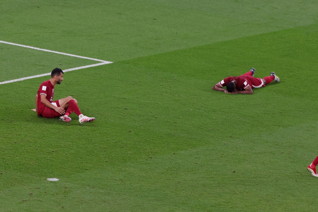 Qatar players look dejected after Senegal’s Bamba Dieng scores their third goal. Photo: Reuters