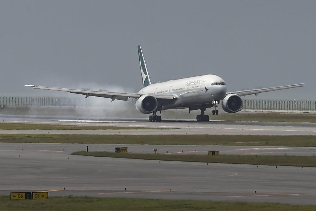 A Cathay Pacific flight touches down after the official opening of the airport’s third runway. Photo: Yik Yeung-man