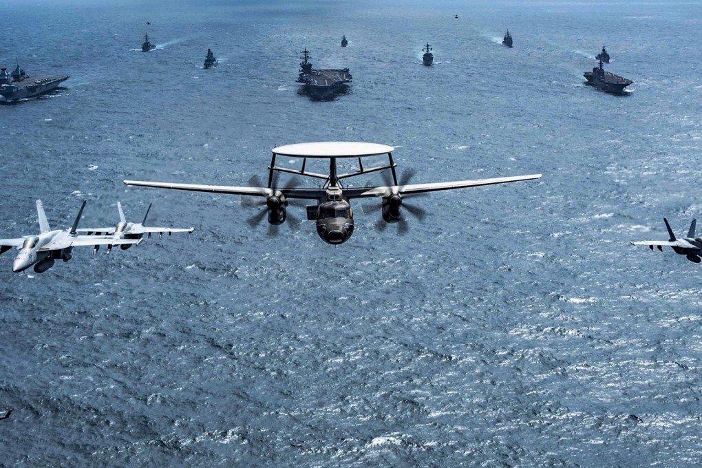 Ships and aircraft from Japan, Australia, Britain and the US fly and sail in formation during joint exercises held in October last year. Photo: US Navy Handout