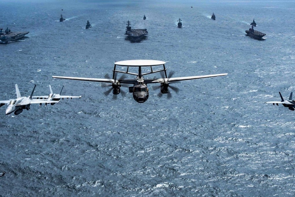 Ships and aircraft from Japan, Australia, Britain and the US fly and sail in formation during joint exercises held in October last year. Photo: US Navy Handout