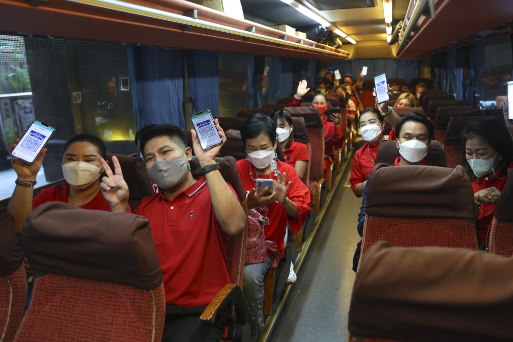 Members of a tour group from Thailand show off their blue health codes in Hong Kong. The tourists were unable to dine out at restaurants until the final day of their four-day trip due to the city’s ongoing Covid travel restrictions. Photo: Yik Yeung-man