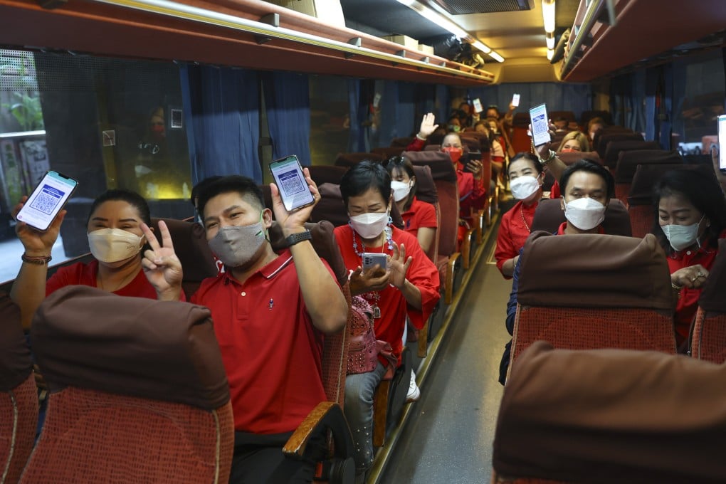Members of a tour group from Thailand show off their blue health codes in Hong Kong. The tourists were unable to dine out at restaurants until the final day of their four-day trip due to the city’s ongoing Covid travel restrictions. Photo: Yik Yeung-man