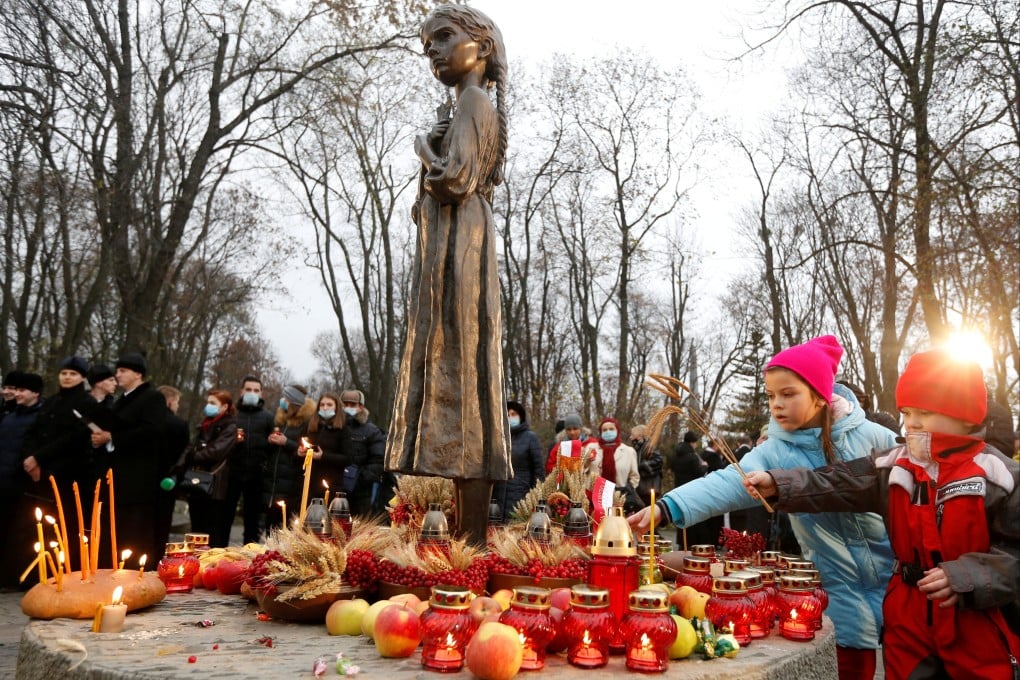 Children place ears of wheat as they visit a monument for Holodomor victims of the famine of 1932-33, in which millions died of hunger. Photo: Reuters