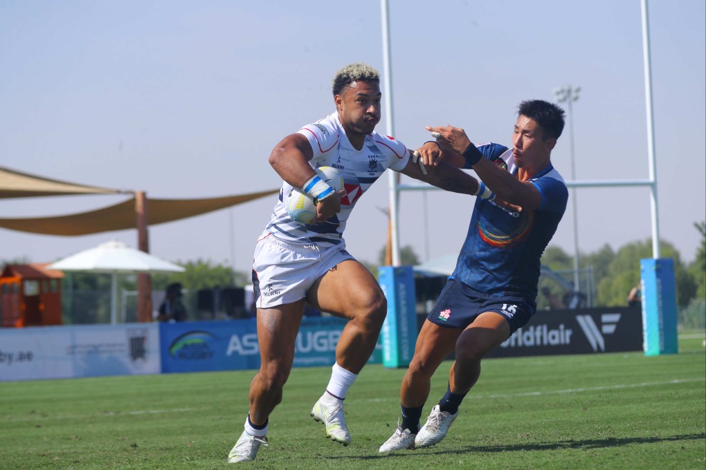 Max Denmark stiff arms a defender during Hong Kong’s semi-final against Japan in the Asia Rugby Sevens Series leg in Al Ain, Abu Dhabi. Photo: Asia Rugby