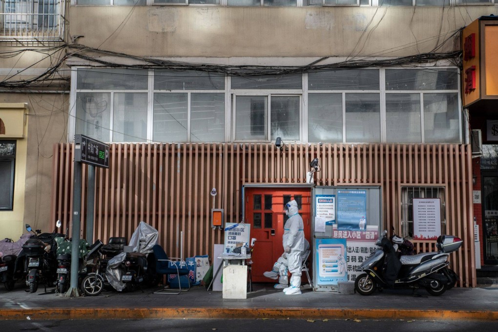 Covid-prevention workers guard the entrance of a residential building placed under lockdown in Beijing, China, on Saturday. Photo: Bloomberg