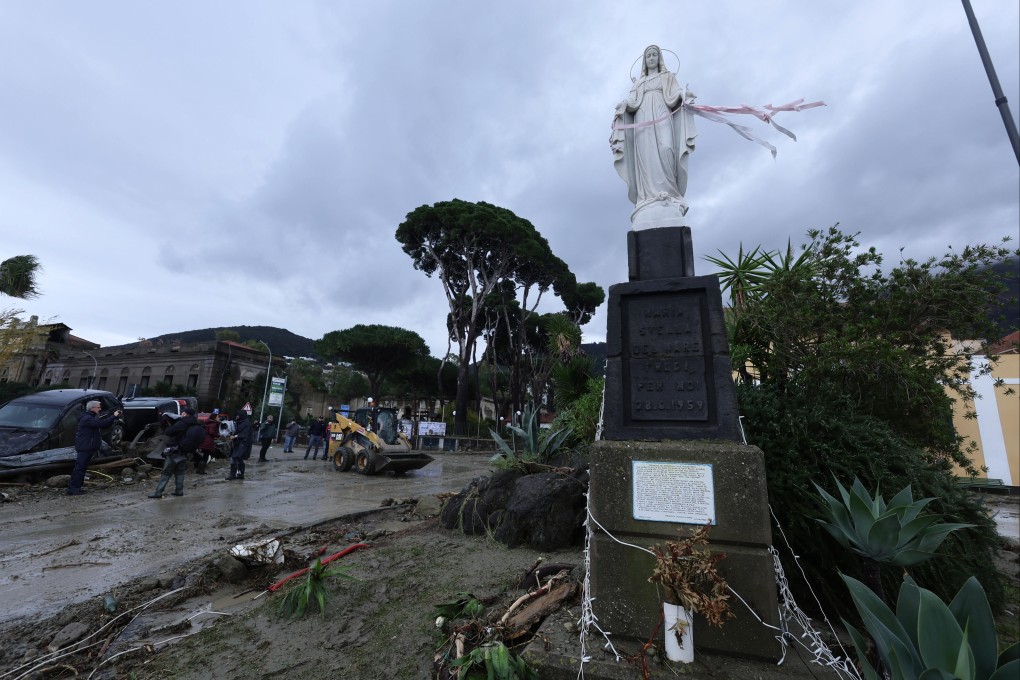 Rescuers remove mud from a street after heavy rainfall triggered landslides in Casamicciola, on the Italian island of Ischia on Saturday. Photo: LaPresse via AP