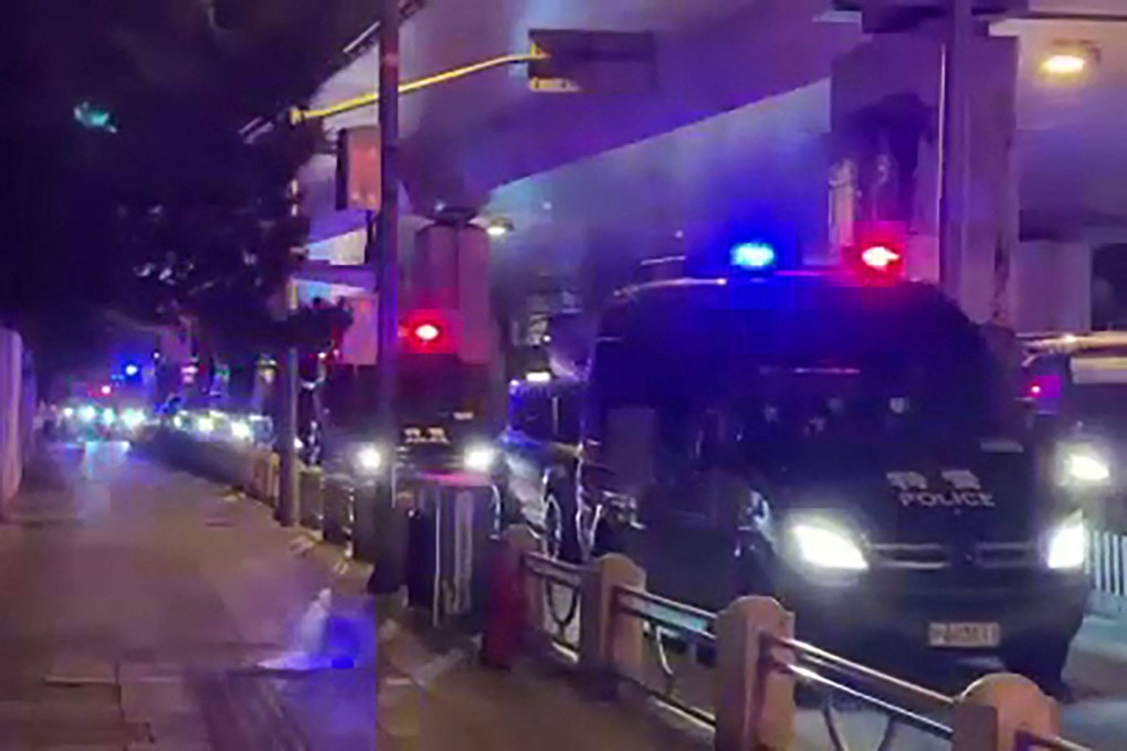 This frame grab taken from video on November 27 by an anonymous source shows a line of police vehicles during protests against China’s Covid-19 restrictions in Shanghai. Photo: AFP