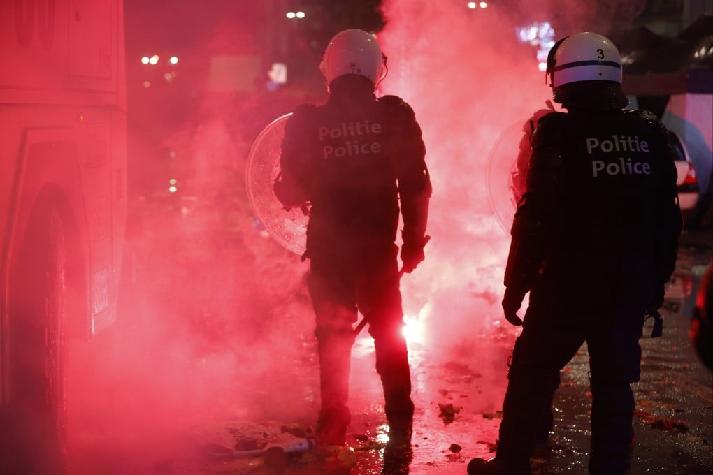 Riot police deploy during clashes with Moroccan football fans in the streets of Brussels, Belgium on Sunday. Photo: EPA-EFE
