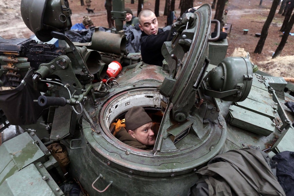 Ukrainian servicemen repair a captured Russian tank in a forest near the front line in the Kharkiv region. Photo: AFP