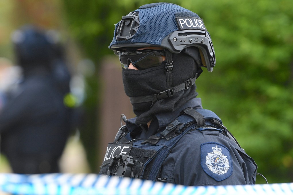 Australian police officers stand outside a property in a suburb of Melbourne during a counterterrorism raid in 2018. Photo: AAP via Reuters