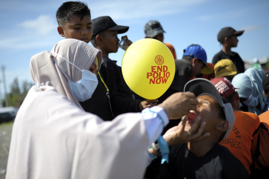 A medical worker administers a vaccine to a boy during a polio immunisation campaign in Indonesia. Photo: AP