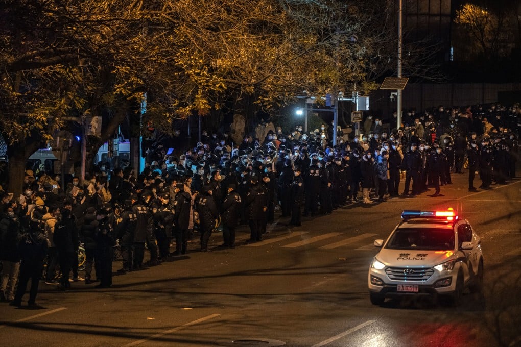 Protesters and police gather during a protest against China’s strict zero-Covid measures on Monday in Beijing. Photo: Getty Images/TNS