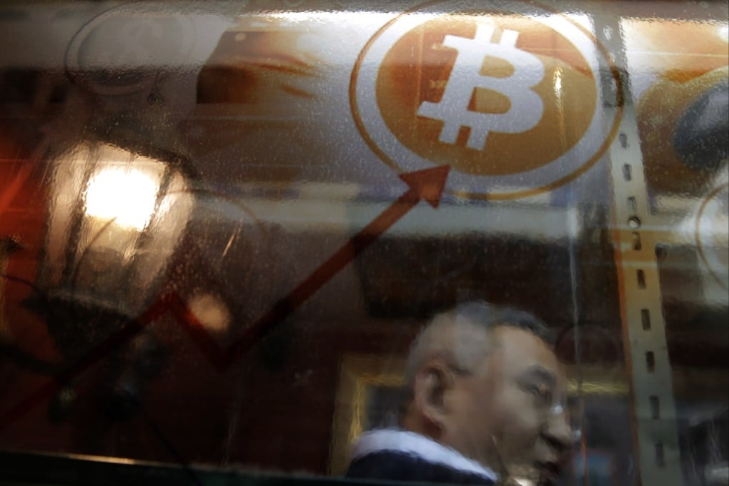 A man uses a bitcoin ATM in Hong Kong on January 11, 2018. The Securities and Futures Commission has introduced new rules for virtual assets that would regulate cryptocurrencies as a new asset class. Photo: AP