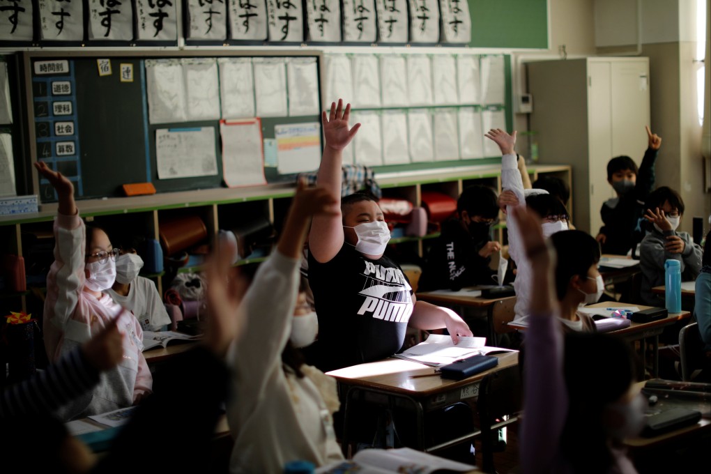 Japan’s education ministry said it would ask schools to proactively get students to remove their masks where they are not necessary. File photo: Reuters
