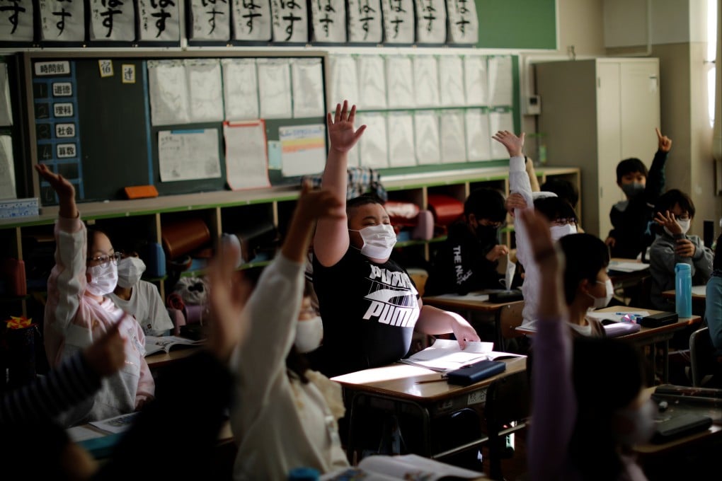 Japan’s education ministry said it would ask schools to proactively get students to remove their masks where they are not necessary. File photo: Reuters