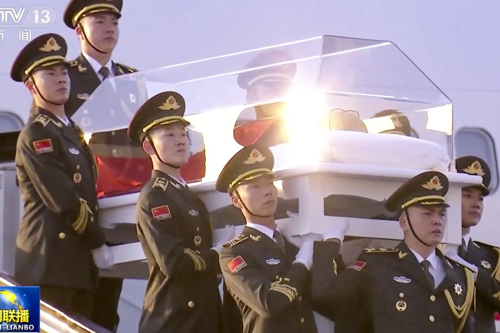 Troops carry Jiang Zemin’s casket down the steps from the plane that brought his body from Beijing. Photo: CCTV