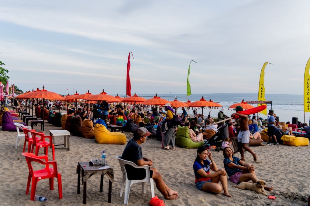 People hang out at Seminyak Beach, Bali, in the evening. Tourism on the Indonesian island is picking up again as the Covid-19 pandemic eases. Photo: Getty Images