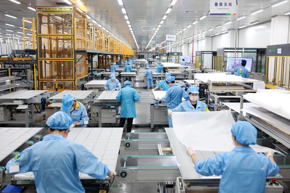 Employees work on photovoltaic solar panels at a factory in Ningbo, Zhejiang province, China in February 2019. Photo: Zhejiang Daily via Reuters