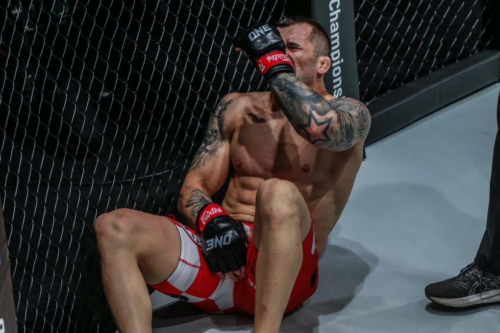 Roberto Soldic writhes in pain after absorbing a low-blow in his ONE Championship debut. Photo: ONE Championship.