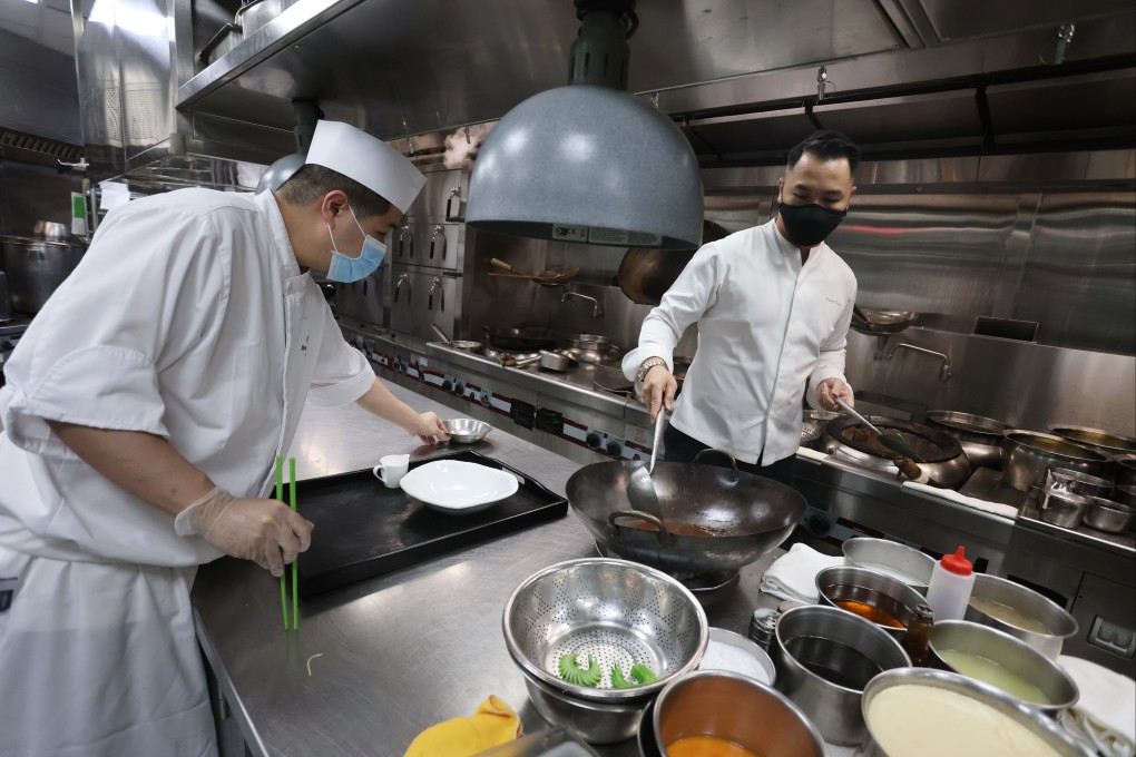 Jayson Tang (right) cooks up a storm at Man Ho Chinese Restaurant in the JW Marriott Hotel in Admiralty. Photo: Jonathan Wong