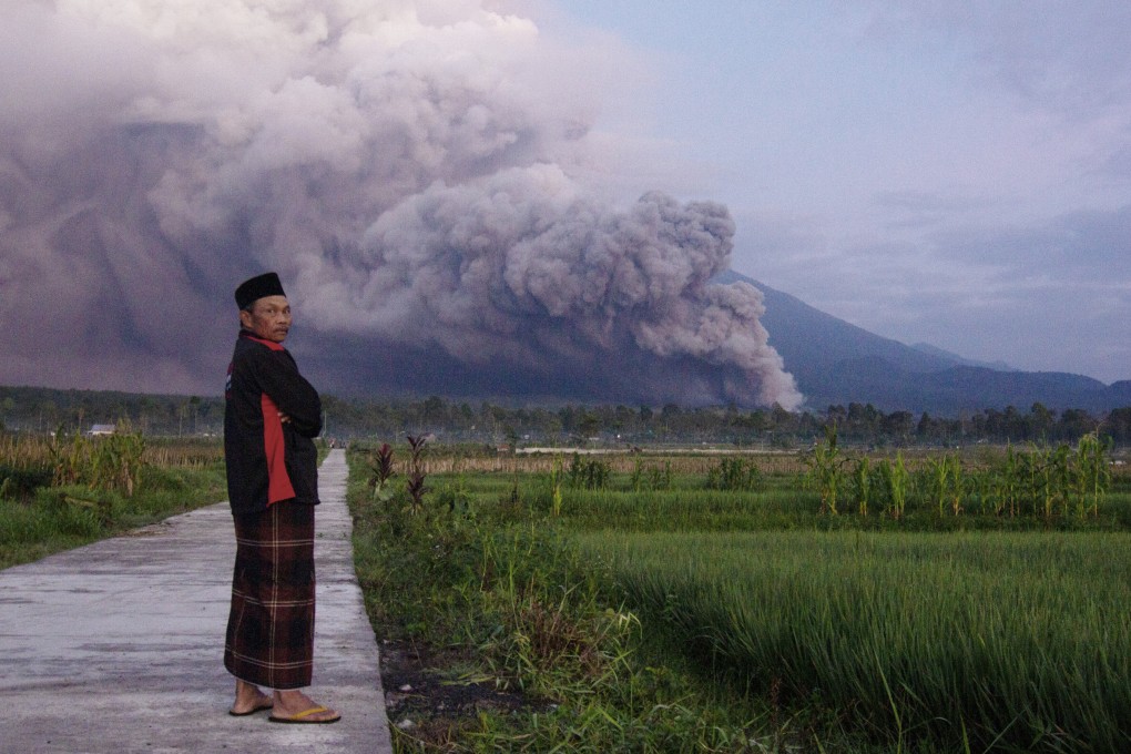A man looks on as Mount Semeru releases volcanic materials during an eruption on Sunday. Photo: AP