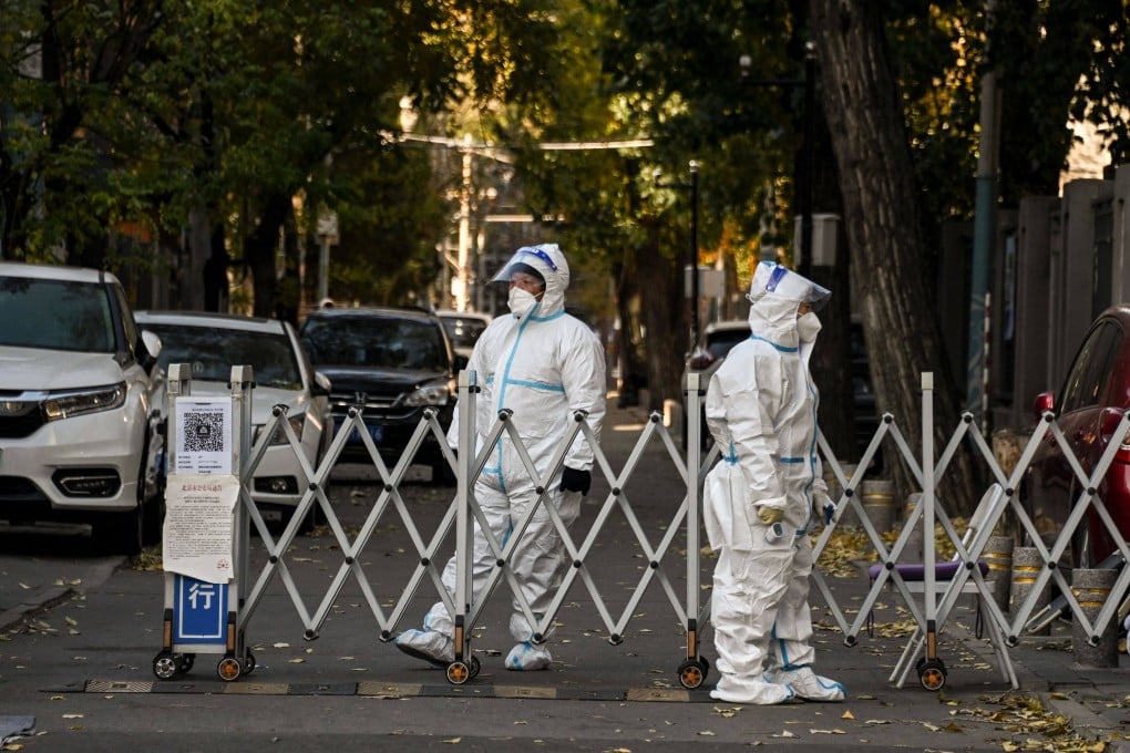 Security officials guard an entrance to a residential area under lockdown due to Covid-19 restrictions in Beijing on November 26. Photo: AFP