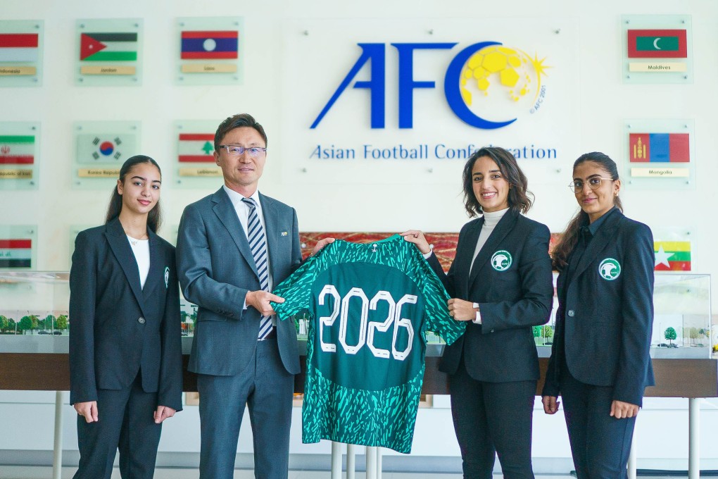 Saudi Arabia’s women’s national team assistant coach Dona Rajab (centre) presents a jersey to Jinho Yu, head of the Asian Cup office, as Marya Baghaffar (left) and Raghad Helmi look on. Photo: Handout