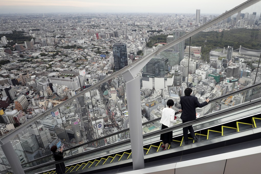 Visitors look out at the view while riding an escalator at Shibuya Sky, the observation deck at the rooftop of Shibuya Scramble Square in Tokyo, in 2020. Photo: Bloomberg