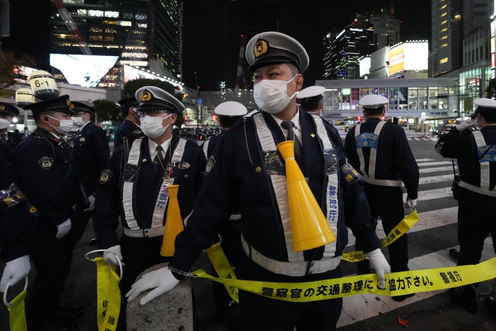 Police in Tokyo. Japanese police have searched the head office of the YamatoQ group and arrested eight of its members. Photo: AP