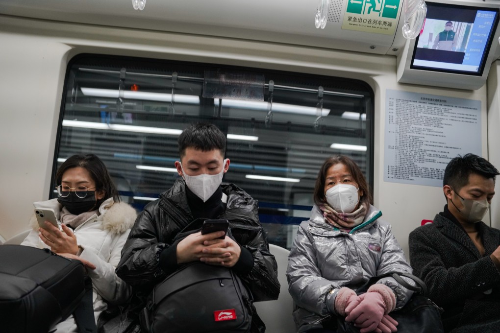 Commuters wear face masks on a train in Beijing on Monday as some major cities have begun to 
ease their coronavirus restrictions. Photo: EPA-EFE