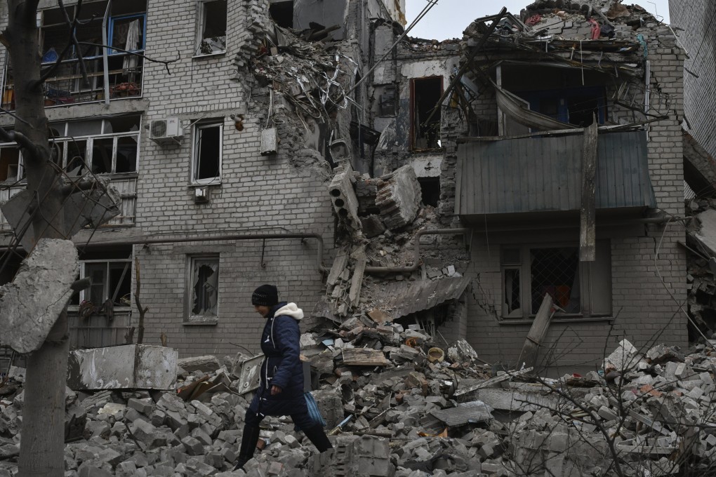 A woman walks past debris of the destroyed house after a recent Russian air strike in Chasiv Yar, Ukraine on November 27, 2022. Photo: AP