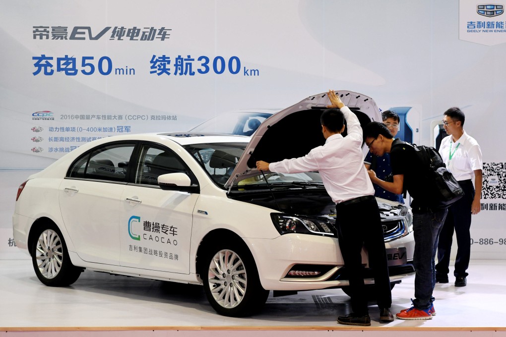 Men look at an electric vehicle of Caocao Zhuanche, a chauffeur ride-hailing platform backed by Zhejiang Geely Holding Group, at a new energy vehicle (NEV) trade fair in 2016. Photo: Reuters