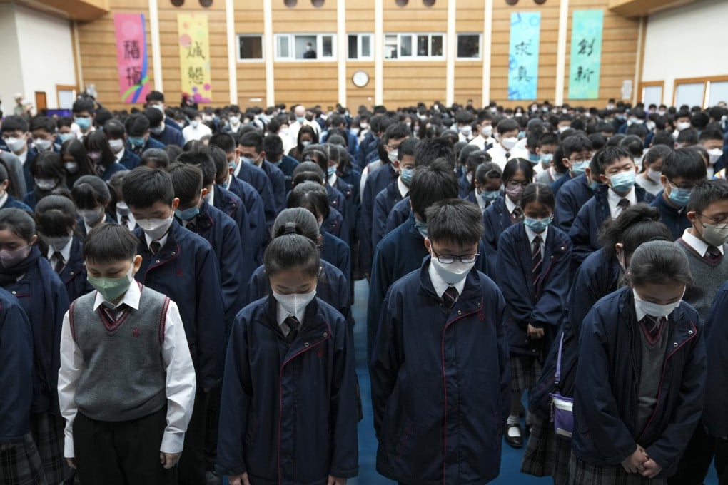 Scientia Secondary School students observing three minutes of silence before the live broadcast of the funeral service. Photo: Sam Tsang