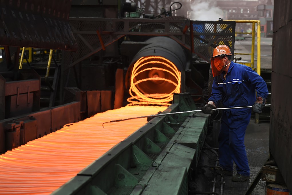 A worker manipulates coils of steel at Xiwang Special Steel in Zouping County in eastern China’s Shandong province in March 2018. Photo: AP