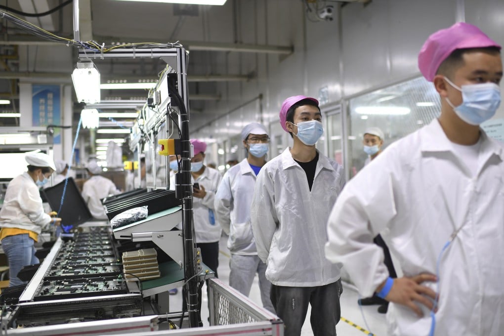 Workers queue up to get tested for Covid-19 at the Foxconn factory in Wuhan, Hubei province, on August 5, 2021. Labour shortages and demonstrations at the Foxconn factory in Zhengzhou have renewed concerns over China’s increasingly precarious place in the global supply chain. Photo: AP