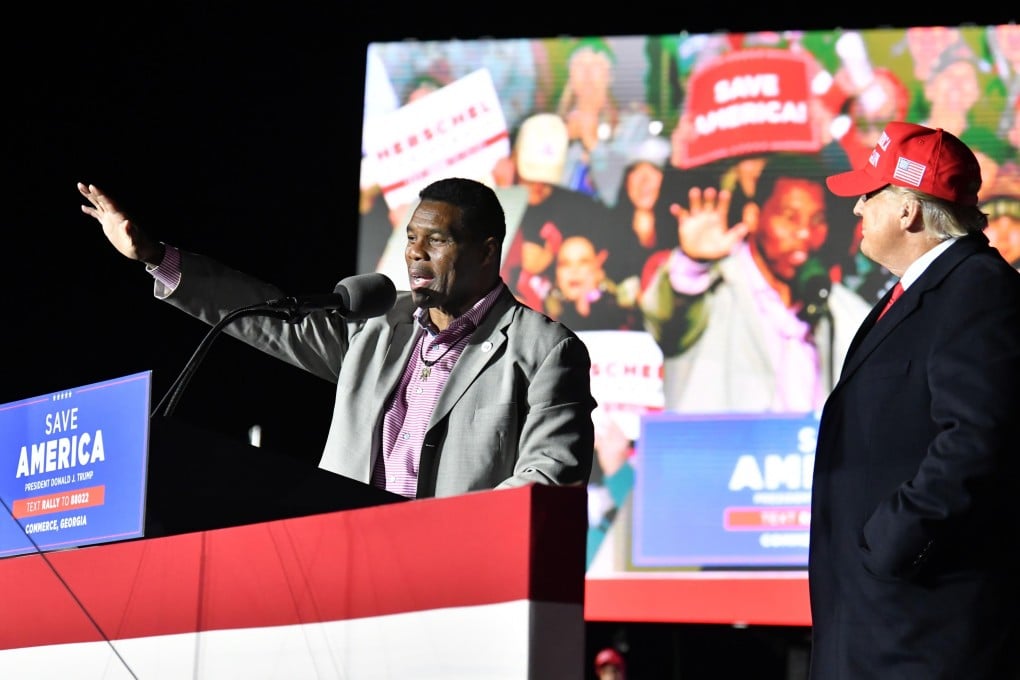 Herschel Walker speaks as former US president Donald Trump looks during a rally for Georgia Republican candidates at Banks County Dragway in Commerce, Georgia on March 26. Photo: TNS