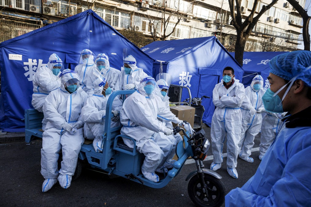 Pandemic prevention workers head for buildings where residents are under home quarantine in Beijing. Photo: Reuters