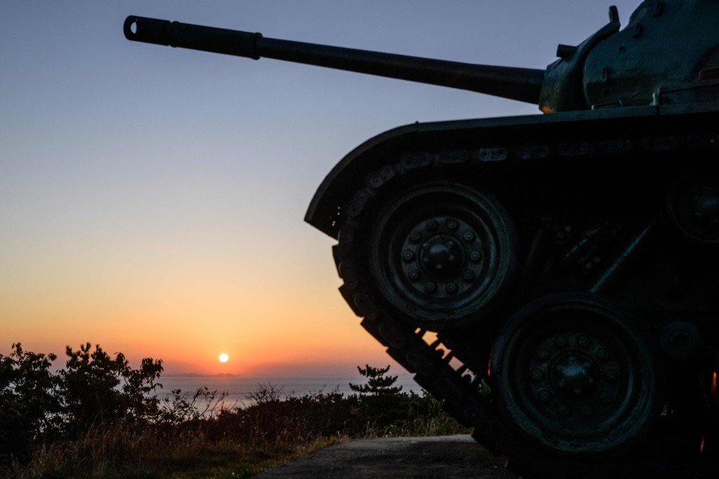 The sun rises over North Korea’s mainland, photographed near a disused tank at a viewing point on the South’s Baekryeong Island, 14km away. Photo: AFP