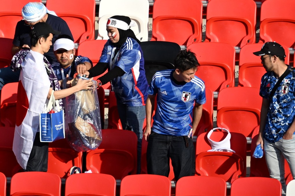 Fans of Japan clean up their trash as they leave the stadium after their team’s World Cup match against Costa Rica at the FIFA World Cup in Qatar. Photo: Serhat Cagdas/Anadolu Agency via Getty Images