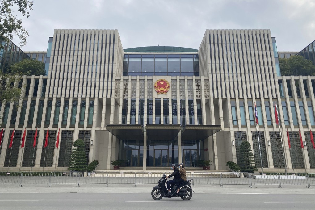 People ride past the National Assembly building in Hanoi, Vietnam. At the 11th National Congress of the Communist Party of Vietnam (CPV) in 2011, Vietnam announced the goal of raising its international standing.  Photo: AP