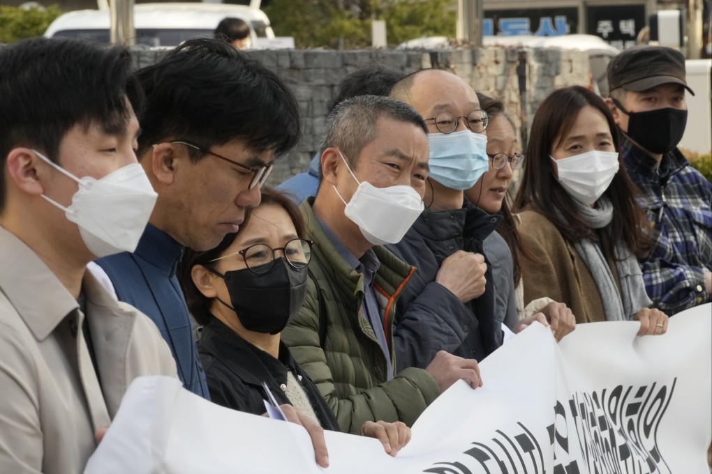 Peter Møller (green jacket), lawyer and co-founder of the Danish Korean Rights Group, attends a press conference with South Korean adoptees in November. Photo: AP