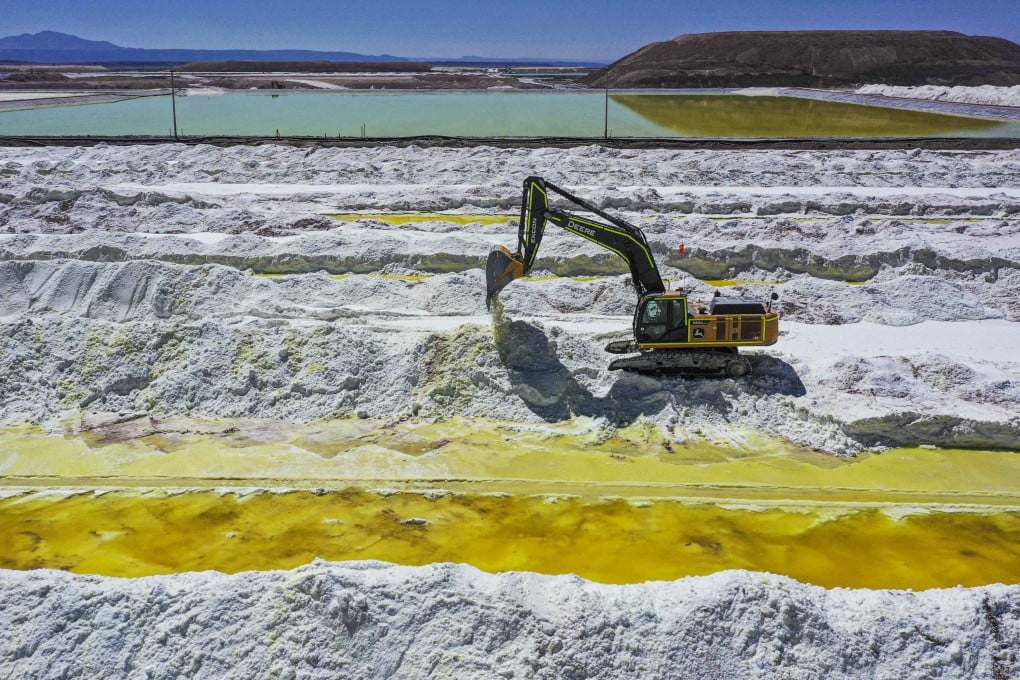 Aerial view of brine ponds and processing areas of the lithium mine operated by Chilean company SQM (Sociedad Quimica Minera) in the Atacama Desert, Calama, Chile, on September 12, 2022. - The turquoise glimmer of open-air pools meets the dazzling white of a seemingly endless salt desert where hope and disillusionment collide in Latin America’s “lithium triangle.” A key component of batteries used in electric cars, demand has exploded for the “white gold” found in Argentina, Bolivia and Chile in quantities larger than anywhere else in the world. (Photo by Martin BERNETTI / AFP)