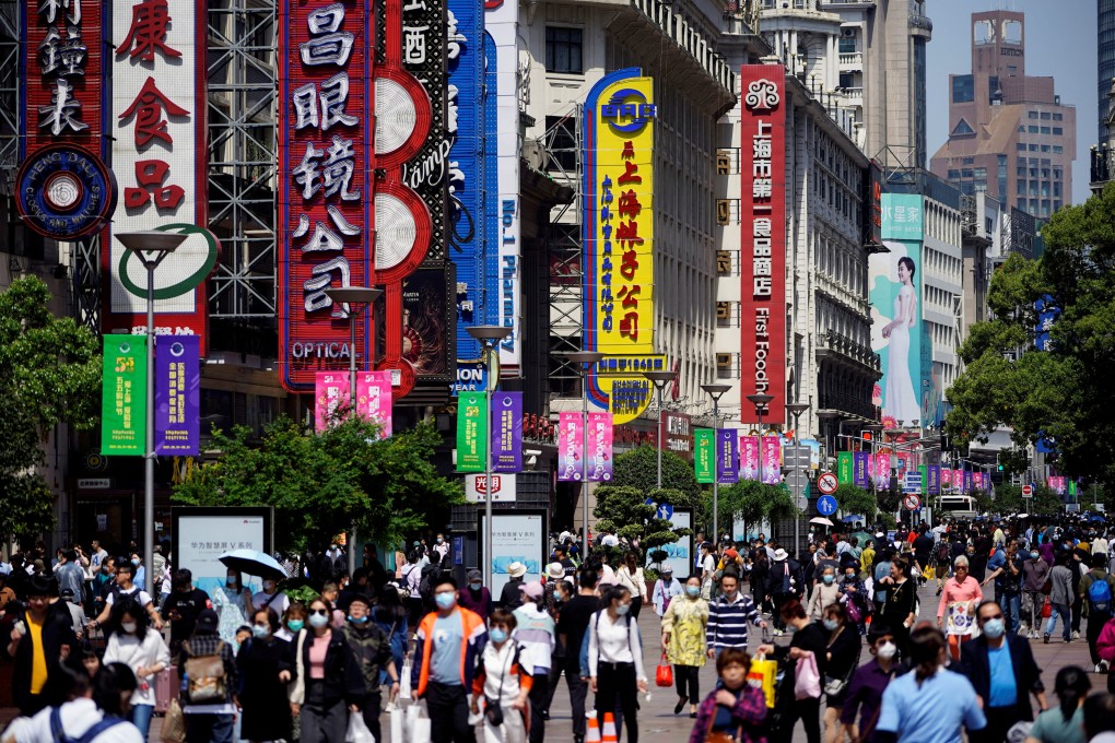 People walk along Nanjing Pedestrian Road, a main shopping area in Shanghai in May 2021. Photo: Reuters